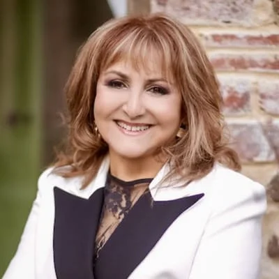 Anne Wilson CEO of Emerge Australia wearing a white blazer and smiling.